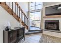 Living room featuring stairs, fireplace, large windows for natural light and modern decor at 10335 E Peakview Ave # B, Englewood, CO 80111
