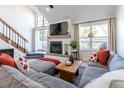 Cozy living room with fireplace, large sectional couch, and access to an outdoor area at 10335 E Peakview Ave # B, Englewood, CO 80111