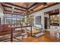 Grand entryway boasting a custom wood ceiling, open floor plan, and an amazing mountain view at 6767 Timbers Dr, Evergreen, CO 80439