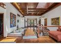 Elegant foyer featuring a custom wood ceiling, open floor plan, and unique architectural elements at 6767 Timbers Dr, Evergreen, CO 80439