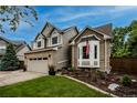 Home exterior showcasing a two-story design with brick and siding, a bay window, an American flag, and a well-manicured lawn at 6255 Collegiate Dr, Highlands Ranch, CO 80130