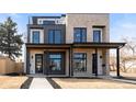 Modern home exterior featuring clean lines, a combination of brick and siding, and inviting curb appeal at 2391 King St, Denver, CO 80211