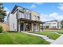 Modern home with a covered porch and landscaped front yard at 2391 King St, Denver, CO 80211