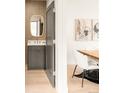 Stylish powder room with modern vanity, unique mirror, and elegant design, located next to dining room at 2391 King St, Denver, CO 80211