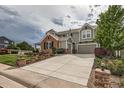 Beautiful two story home with brick and siding, attached two car garage and driveway at 8469 Winter Berry Dr, Castle Pines, CO 80108