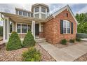 Charming front entrance with well-kept landscaping and a cozy, welcoming porch at 8469 Winter Berry Dr, Castle Pines, CO 80108
