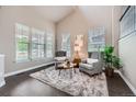 Bright living room featuring vaulted ceilings, two armchairs, a shag rug and large windows at 8469 Winter Berry Dr, Castle Pines, CO 80108