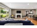Comfortable living room featuring a fireplace and a large window at 2845 Hudson St, Denver, CO 80207