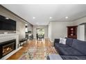 Open-concept living area with a fireplace and seamless flow to dining and kitchen at 2845 Hudson St, Denver, CO 80207