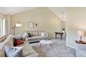 Bright living room featuring neutral tones, vaulted ceilings, and plush seating arrangements at 6083 S Glencoe Way, Centennial, CO 80121