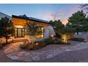 Charming front exterior with walkway, manicured landscaping, mature trees, and outdoor lighting at 3823 Castle Butte, Castle Rock, CO 80109