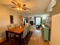 Open concept dining room, with hardwood floors, seamlessly connects to the living room and fireplace at 1732 S Blackhawk Way # D, Aurora, CO 80012
