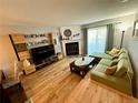 Comfortable living room with hardwood floors, fireplace, and sliding doors to bring in natural light at 1732 S Blackhawk Way # D, Aurora, CO 80012