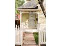 Inviting front porch featuring decorative white railings and a walkway through the lawn at 2909 Glenarm Pl, Denver, CO 80205