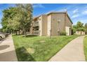 Beautiful condo building showcasing a well-maintained lawn and inviting outdoor spaces at 8225 Fairmount Dr # 102, Denver, CO 80247