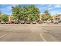 Condo complex parking lot with ample spaces available for residents and guests at 8225 Fairmount Dr # 102, Denver, CO 80247