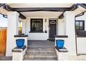 Inviting covered front porch with black trim, featuring brick detailing and a welcoming entrance at 1484 Cherry St, Denver, CO 80220