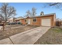 Single-story home featuring neutral siding, an attached garage, and a driveway at 3937 S Truckee St, Aurora, CO 80013