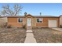 Inviting single-story home with a stone accented entryway and an attached one car garage at 3937 S Truckee St, Aurora, CO 80013