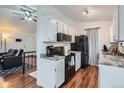Functional kitchen space with white cabinets, laminate countertops, and black appliances at 3937 S Truckee St, Aurora, CO 80013