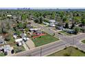 An aerial view of a home with a large yard, mature trees, and a detached garage at 2401 W Jewell Ave, Denver, CO 80219