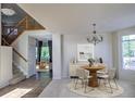 Cozy living room with elegant chandelier, dining table, and staircase in view at 331 Las Lomas St, Brighton, CO 80601