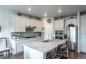 Kitchen with granite countertops, stainless steel appliances, white cabinets and barstool seating at 3936 Costillo Ct, Brighton, CO 80601