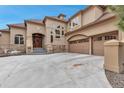 Stunning exterior showcasing a well-maintained three car garage, complemented by a stone facade and ample parking space at 9132 Scenic Pine Dr, Parker, CO 80134