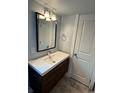 Bright bathroom featuring a modern vanity, sleek faucet, and updated lighting fixture above the mirror at 915 N Irving St, Denver, CO 80204