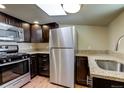 Updated kitchen with stainless steel appliances, granite countertops, and wood-look floors at 915 N Irving St, Denver, CO 80204