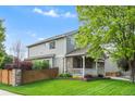 Well maintained home exterior showing landscaping and a fenced yard with a covered porch on a sunny day at 14794 Vine St, Thornton, CO 80602