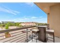 Balcony with a table and chairs overlooking a parking lot and other buildings in a pleasant outdoor space at 10111 Inverness Main St # 301, Englewood, CO 80112