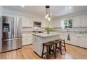 Bright kitchen with stainless steel appliances, granite countertops, and center island with seating at 3090 S High St, Denver, CO 80210