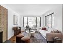 Bright and airy living room with a large window, modern decor, and a cozy atmosphere at 1695 E Eastman Ave, Englewood, CO 80113