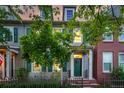 View of the home's exterior with well-manicured lawn and a welcoming green front door at 8421 E 29Th Ave, Denver, CO 80238
