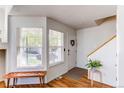 Bright and airy entryway with wood floors and bench at 13900 Lake Song Ln # B6, Broomfield, CO 80023