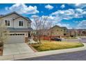 Exterior of a two-story home with attached garage, stone accents, and a well-manicured lawn at 4808 S Picadilly Ct, Aurora, CO 80015