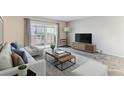Bright living room with sliding glass doors, neutral decor, and modern furniture at 9385 E Center Ave # 6A, Denver, CO 80247