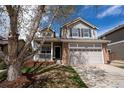 Attractive two-story home with an attached two-car garage and front porch at 1169 Thornbury Pl, Highlands Ranch, CO 80129