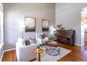 Bright living room with high ceilings, stylish furnishings, and warm hardwood floors at 1169 Thornbury Pl, Highlands Ranch, CO 80129