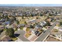 Expansive aerial view showcasing the neighborhood's layout, nearby tennis courts, playground and community amenities at 3785 E 134Th Ct, Thornton, CO 80241