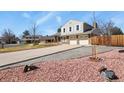 Two-story home with a well-maintained lawn and landscaping, featuring a long driveway at 3785 E 134Th Ct, Thornton, CO 80241