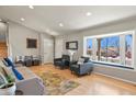 Bright living room featuring a bay window with seating, hardwood floors, and modern decor at 3785 E 134Th Ct, Thornton, CO 80241