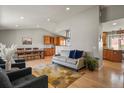 Inviting living room featuring hardwood floors, neutral decor, and an open layout to the kitchen area at 3785 E 134Th Ct, Thornton, CO 80241