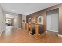 Elegant foyer with hardwood floors, decorative wall niches, and staircase leading to the basement at 5662 W Peakview Pl, Littleton, CO 80123