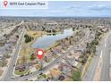 Neighborhood view of home in a peaceful suburban neighborhood with a lake nearby at 18292 E Caspian Pl, Aurora, CO 80013
