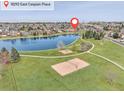 Aerial view of the park with a lake, playground, and volleyball court at 18292 E Caspian Pl, Aurora, CO 80013