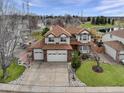 Lovely two-story home with a three car garage, pristine lawn and manicured landscaping at 18292 E Caspian Pl, Aurora, CO 80013