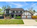 Beautiful two-story home featuring brick and Tudor accents, an attached two-car garage, and a well-maintained lawn at 7706 S Crocker Ct, Littleton, CO 80120