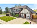 Well-kept two-story home with brick and Tudor accents, an attached two-car garage, and a wide driveway at 7706 S Crocker Ct, Littleton, CO 80120